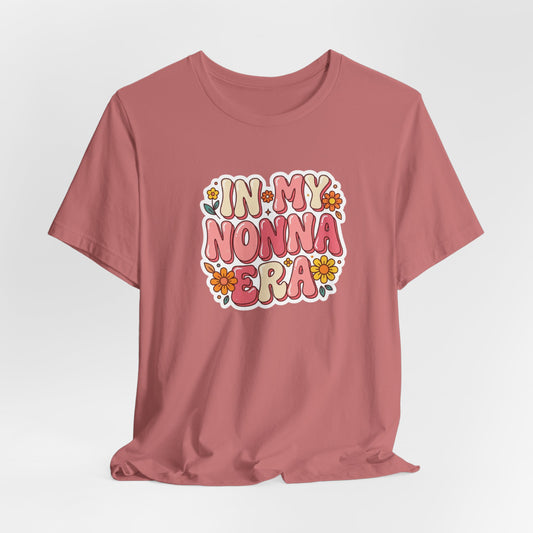 Dusty pink crewneck T-shirt with "In My Nonna Era" floral graphic on chest