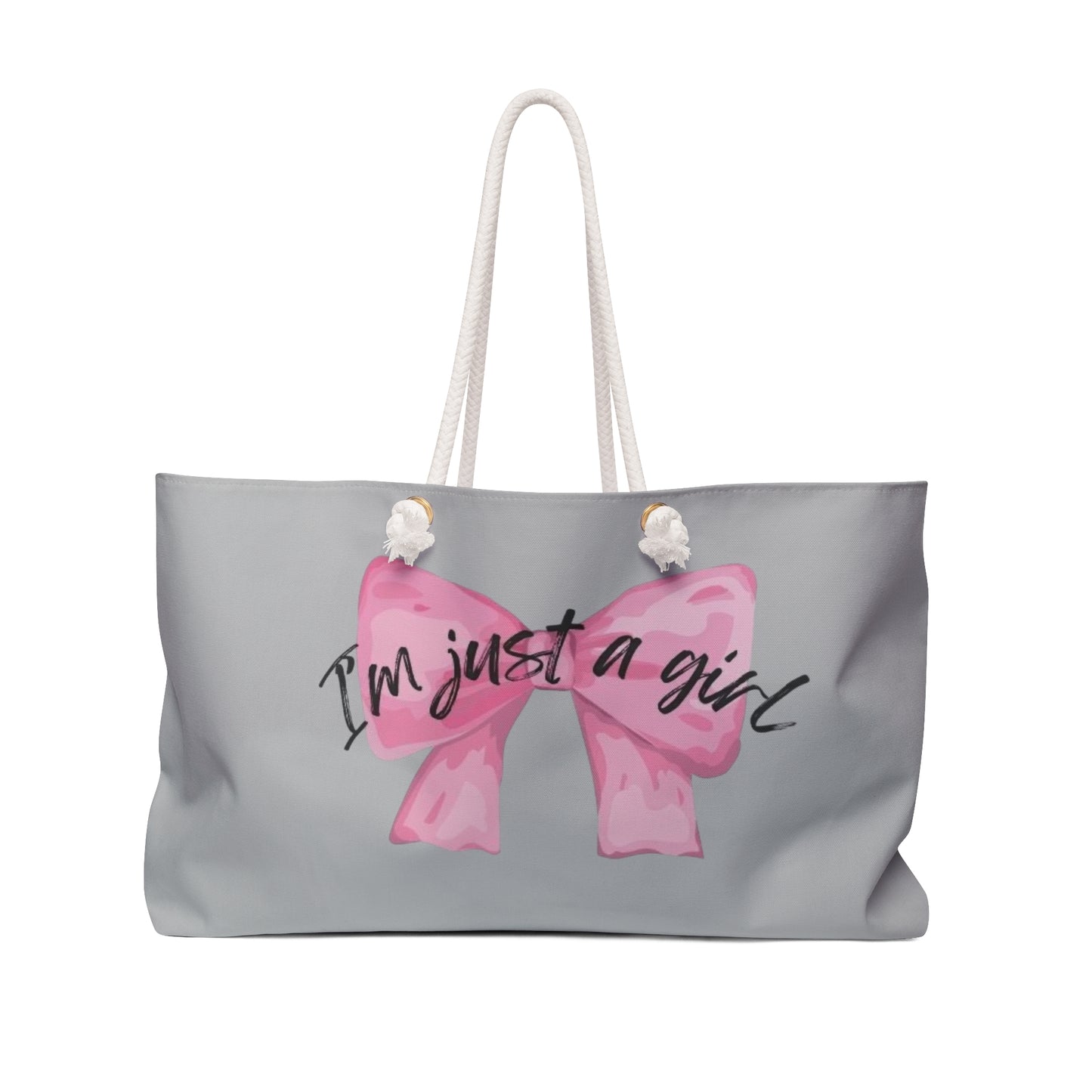 A large tote-style weekender bag with a gray background featuring a floral print. The bag has the text 'I'm just a girl' accompanied by a pink bow graphic on the front.