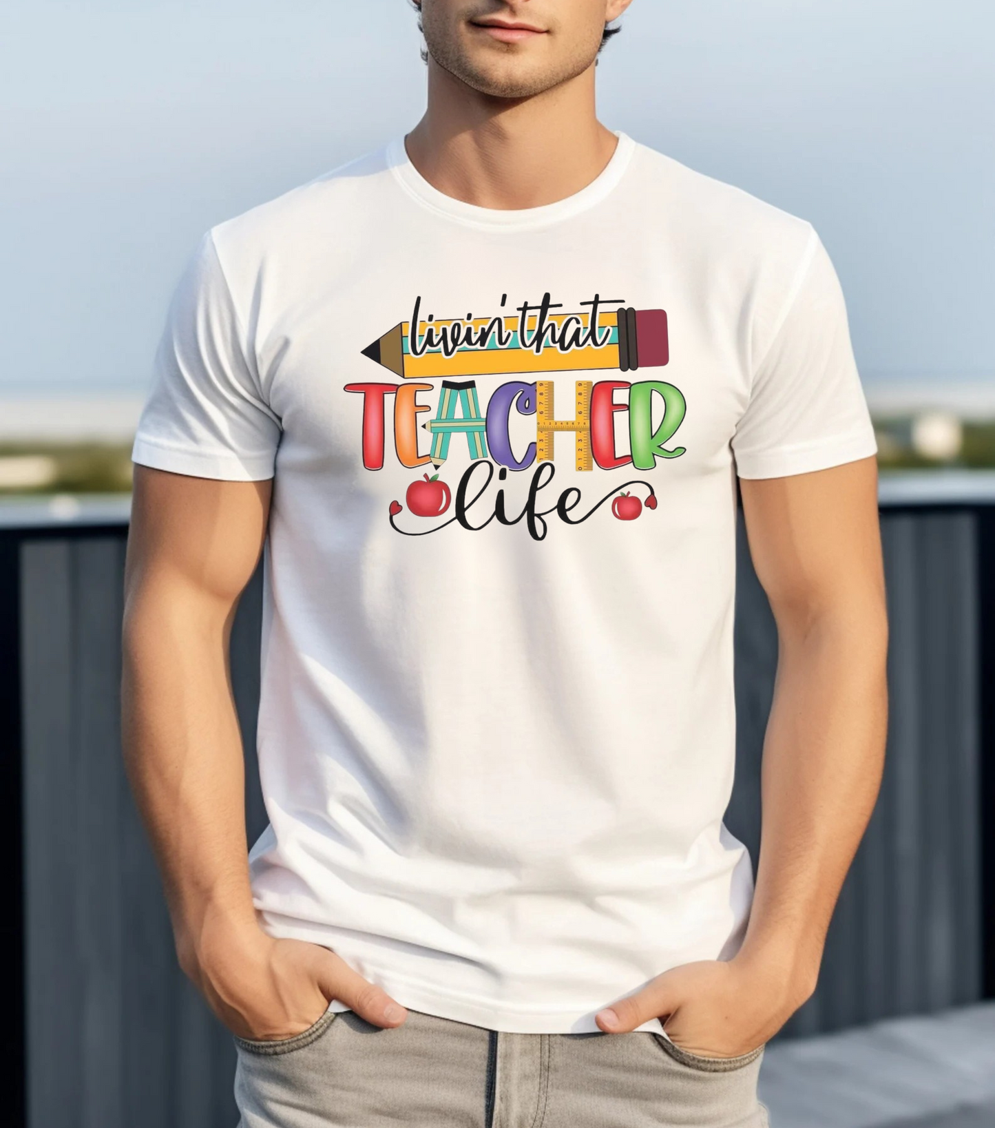 Person wearing a white t-shirt with colorful text and graphics.
