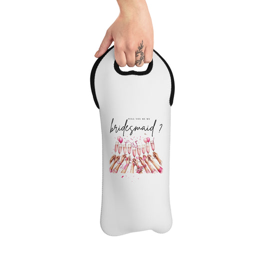 A hand holding a white neoprene wine tote bag with text and floral design, intended for carrying a wine bottle.
