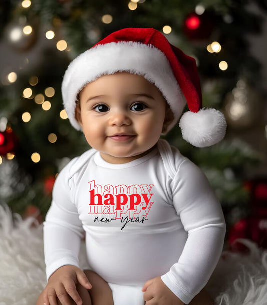 A baby wearing a white bodysuit with 'Happy New Year' and the year '2025' printed on the front, sitting in a festive setting with Christmas decorations.