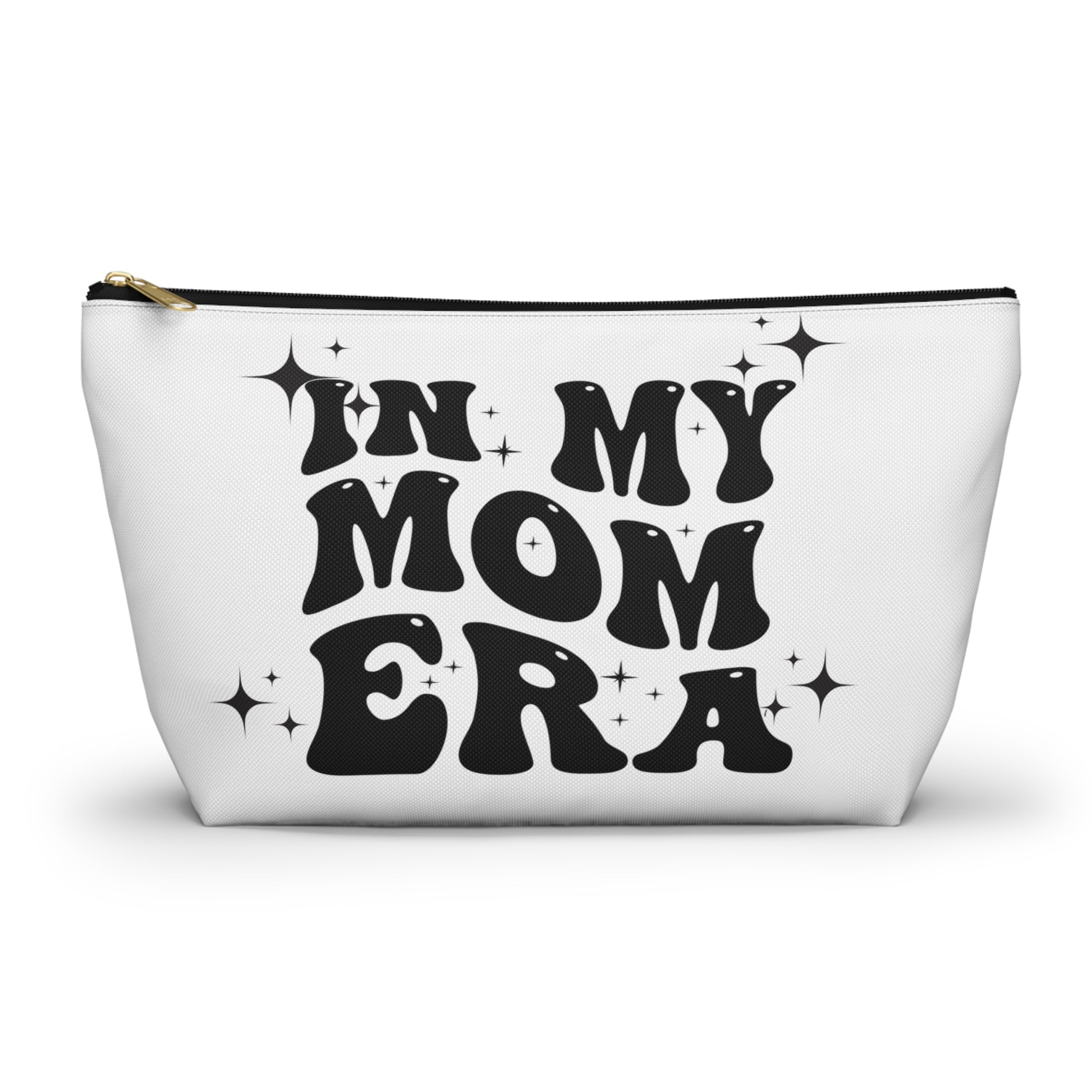 White zippered mom bag with “IN MY MOM ERA” print; black zipper trim and gold pull.