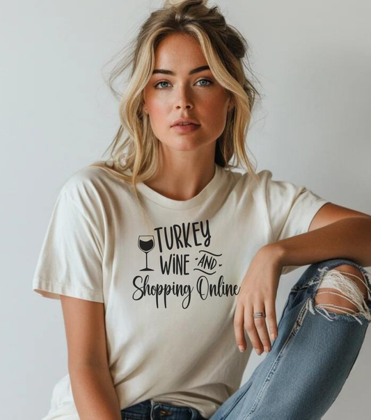 A person wearing a white unisex short-sleeve t-shirt with text 'Turkey Wine and Shopping Online' printed on the front, sitting with a relaxed pose.