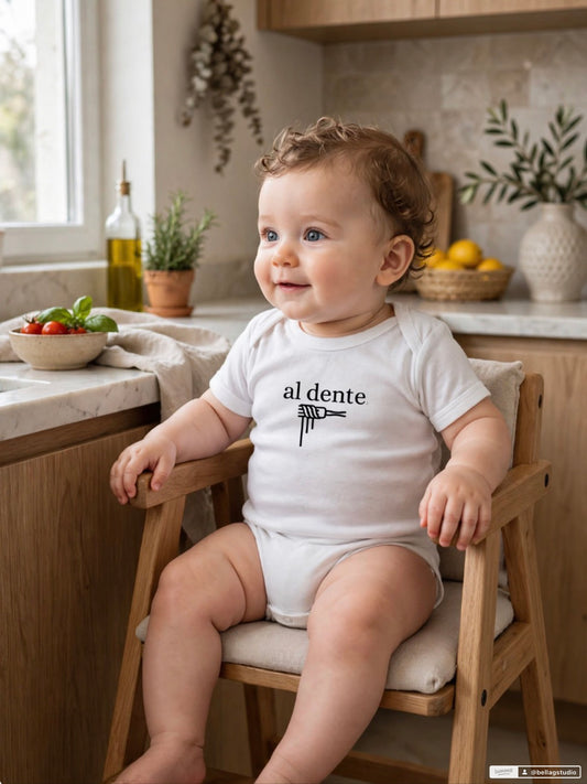Baby wearing al dente bodysuit in Italian kitchen setting