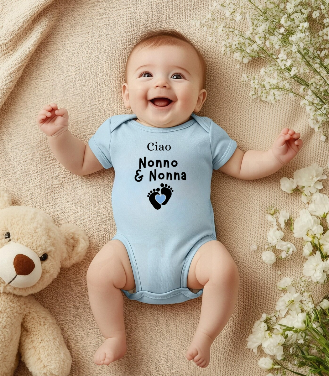 Baby wearing a light blue onesie with text, lying on a beige blanket with flowers and a teddy bear.