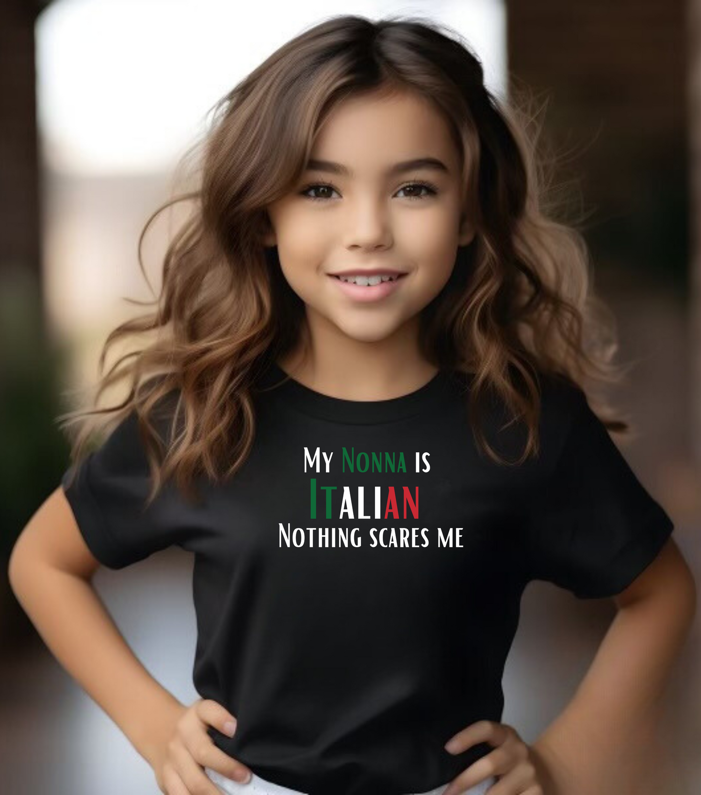 Young girl wearing a black t-shirt with colorful text, standing against a blurred background.