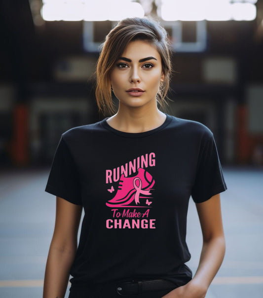 A person wearing a black unisex short-sleeve t-shirt with a pink graphic that reads 'Running to make a change' and a silhouette of a shoe.