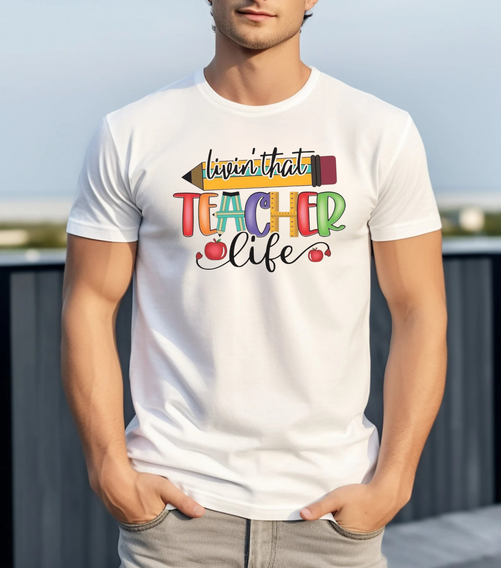 Person wearing a white t-shirt with colorful text and graphics.