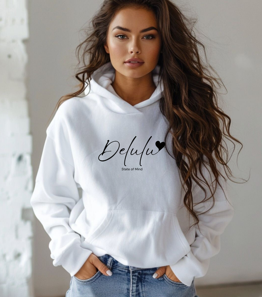 A woman wearing a white hooded sweatshirt with the text 'DELULU' printed on the front.